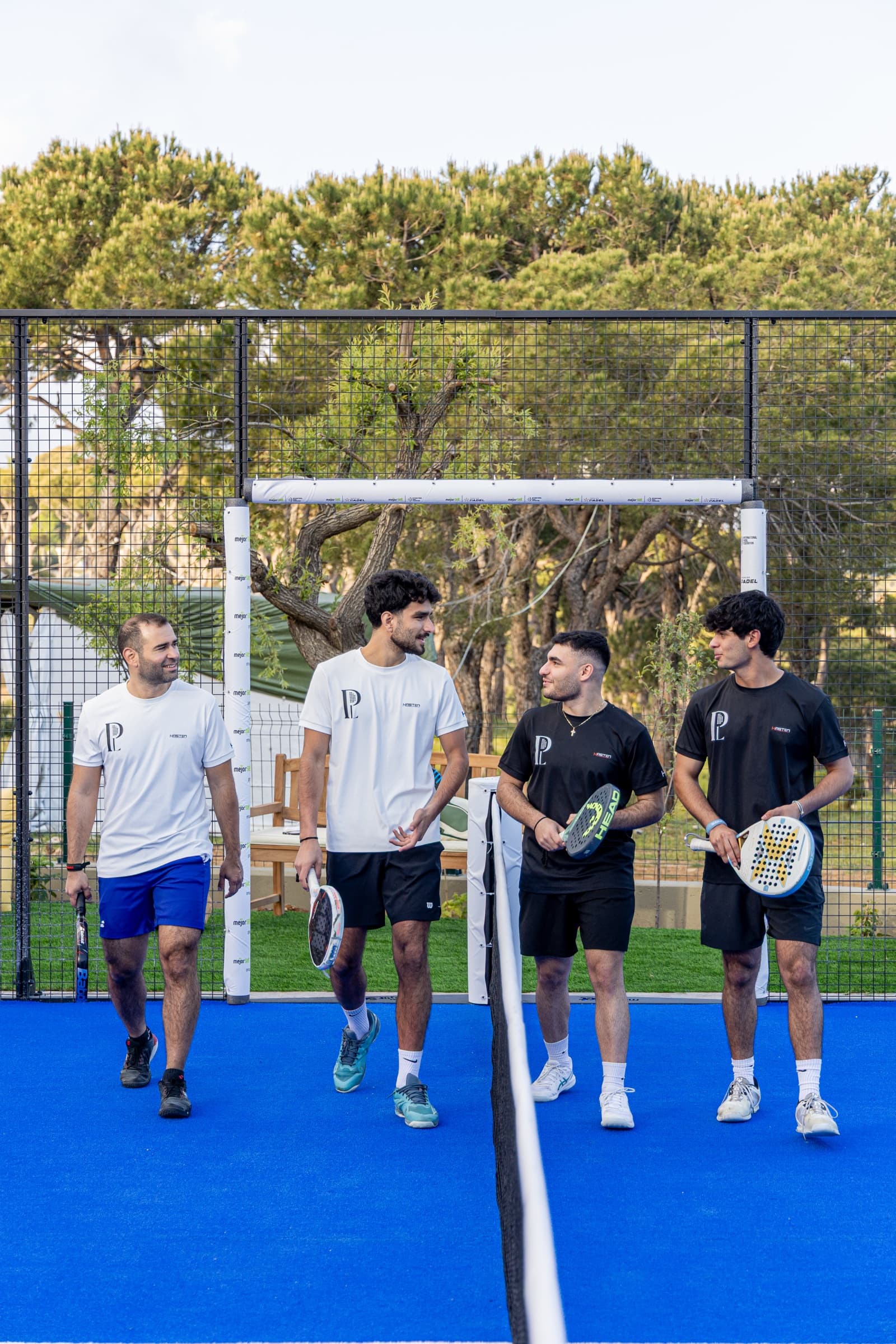 Padel players on the blue court